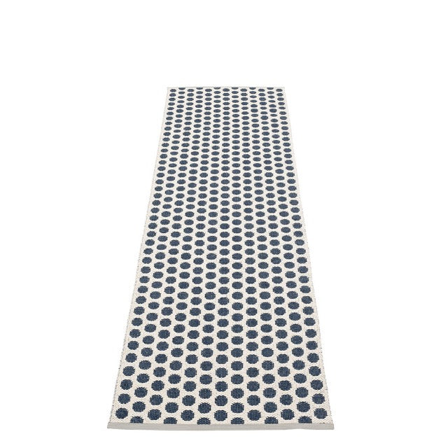 white rug with blue polkadots