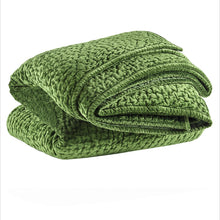 Load image into Gallery viewer, evergreen velvet quilt folded up on a white background
