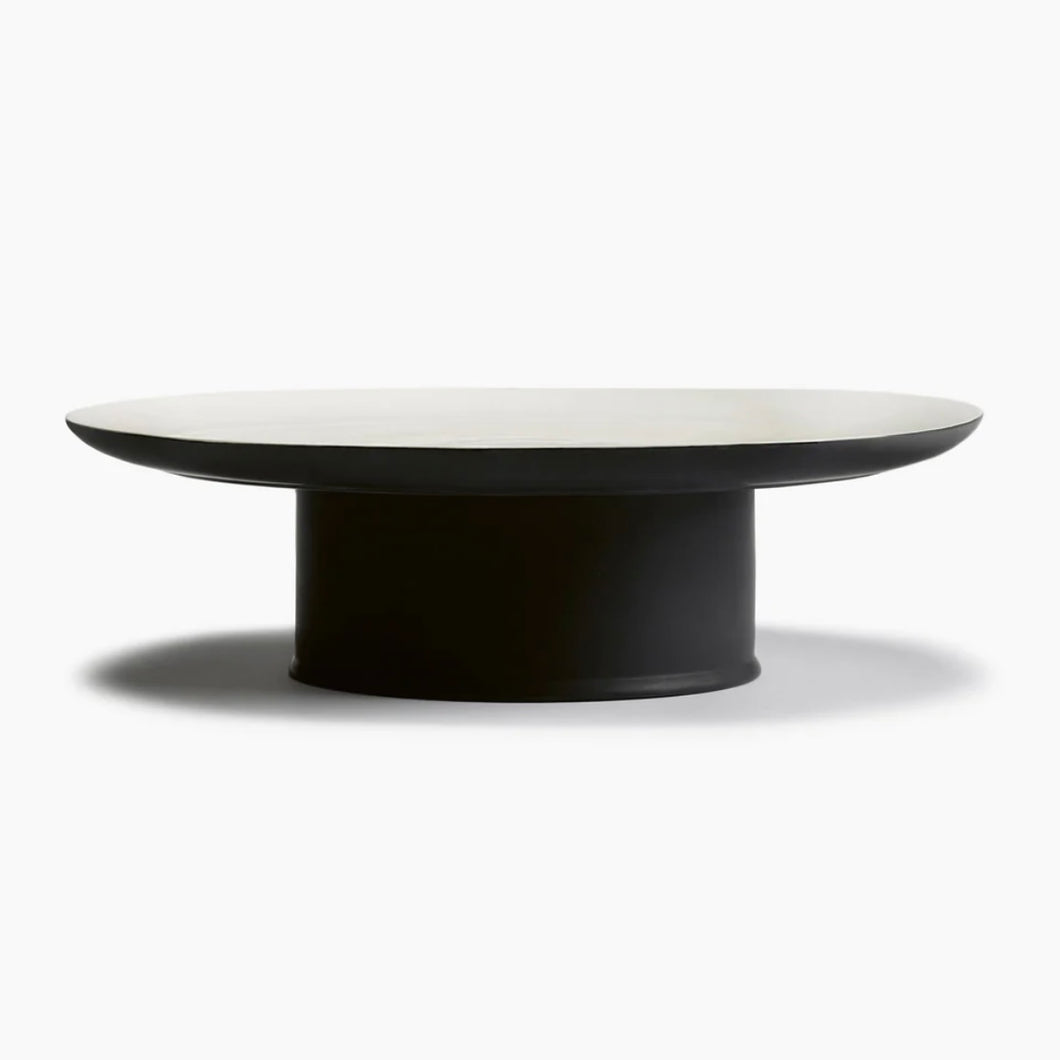 black and white cake stand on a white table